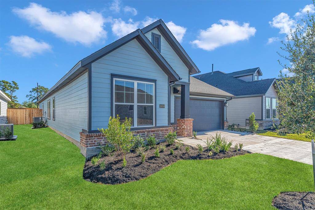 This charming home with a well-maintained lawn, and a two-car garage. It's set in a quiet neighborhood with a welcoming front entrance.