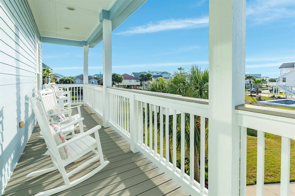 This is the west balcony overlooking the driveway and onto Pirates Beach Blvd Ct. Home was recently painted, and of course all decking materials is composite designed to last many, many years.