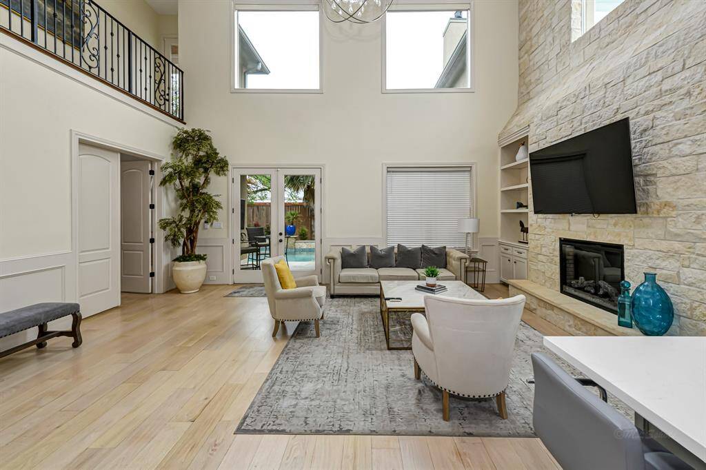 Gorgeous living space is bathed in natural light through all the windows and glass doors