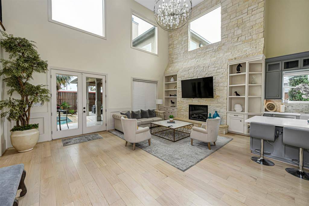 Stone wall hosts the fireplace and offer built in on either side to display your art work