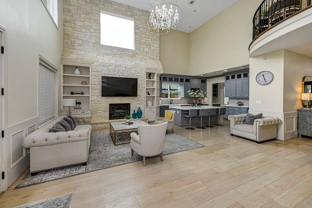 This stunning room is open to the kitchen and boast 20' ceilings