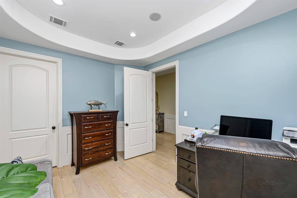 Another view of the home office.  Closed door leads to the Primary closets and Primary bath