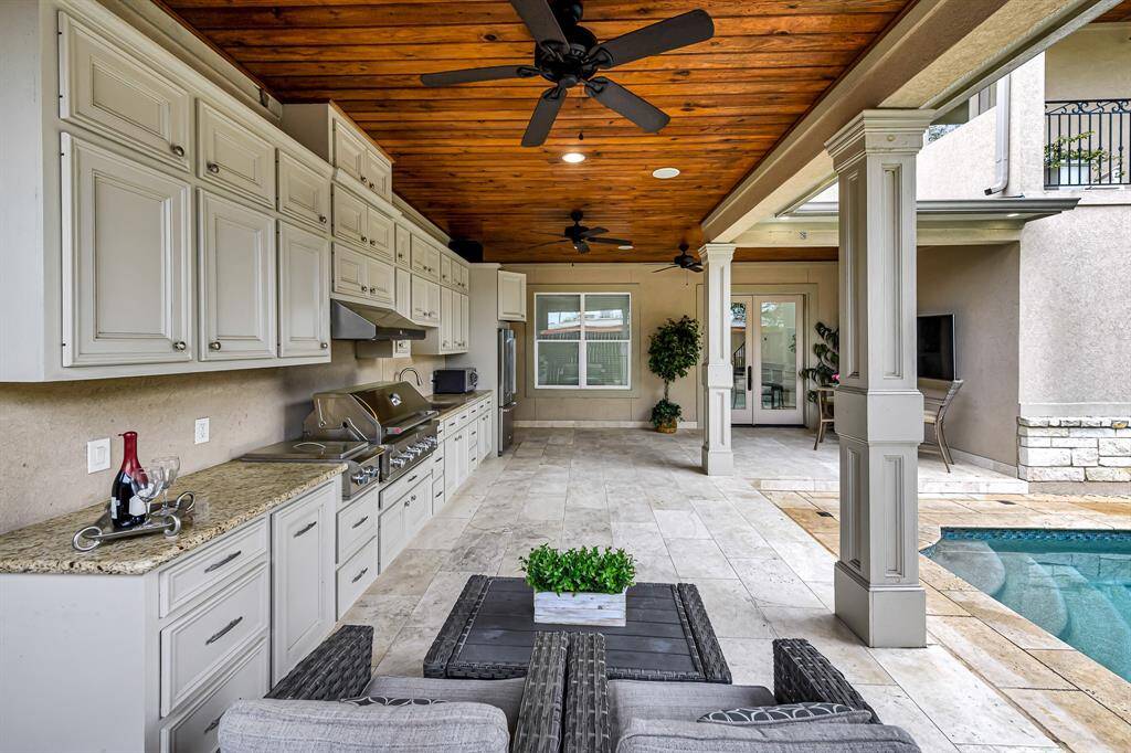 Tons of storage space, build in grill, fridge and outdoor ceiling fans.  Your personal resort awaits