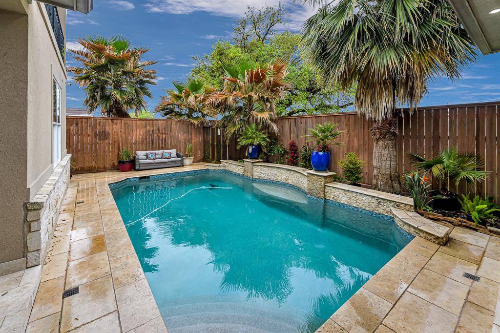 The pool features a cascading waterfall which adds to the peaceful ambiance and creates a serene atmosphere.