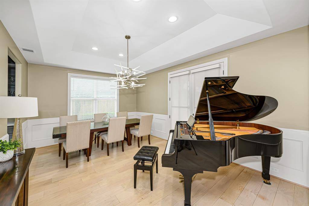 The large dining room is to your right as you enter the home. It is designed to be an elegant and inviting space, perfect for hosting both intimate gatherings and grand dinner parties
