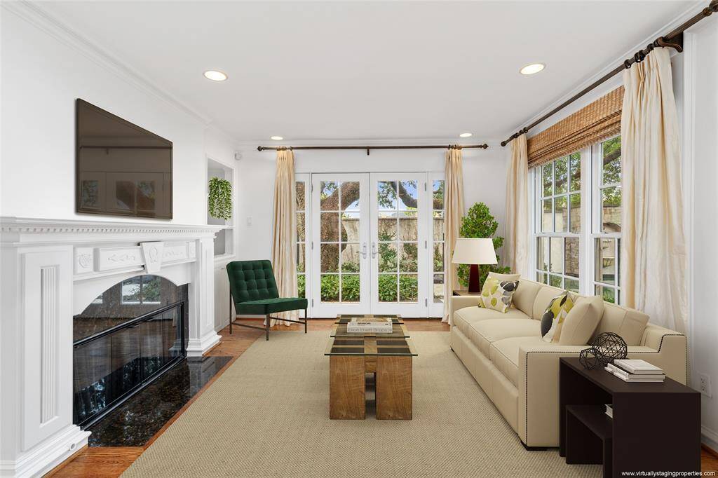 Final view of the family room showing it's central location in the home. Front door and entry hall on the left with French doors to the side patio and pool on the right. Virtually Staged.