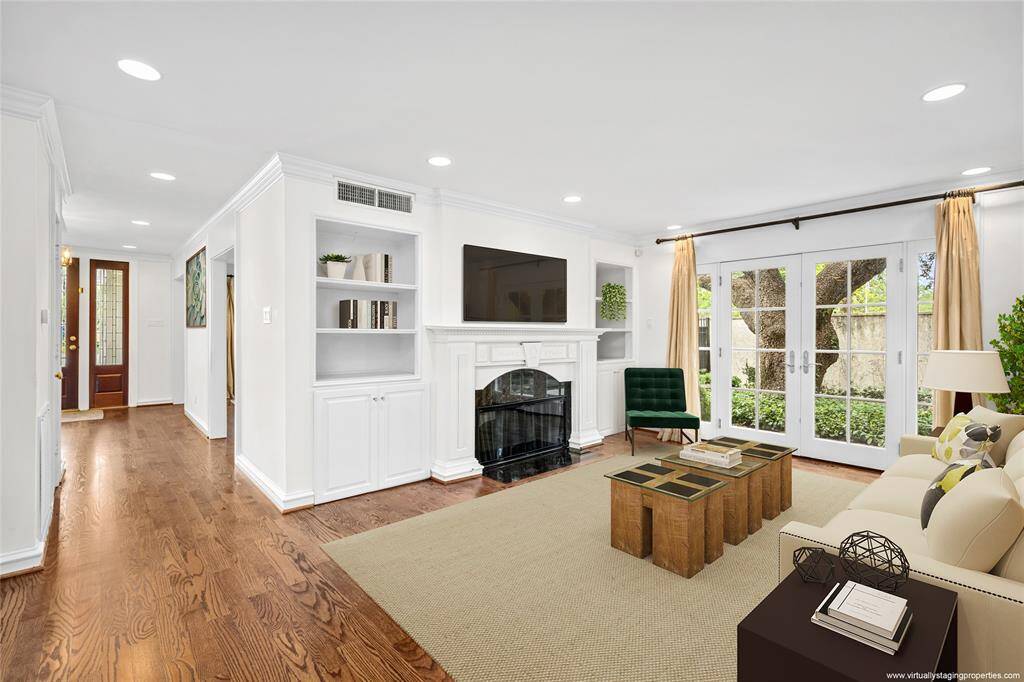 Large kitchen with newly installed Calacatta marble on the breakfast island and counters (2023 per seller), opens to the family room. New (2023 per seller) hardwood floors shine in the natural light.