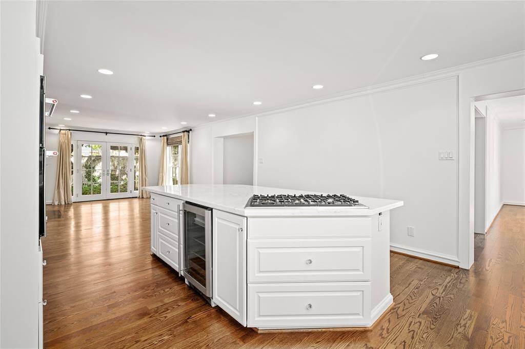First floor primary bedroom. Muti-point divided lite doors to the pool/patio. Coffered ceiling and crown molding. Entry to the heavenly primary bathroom on the right.