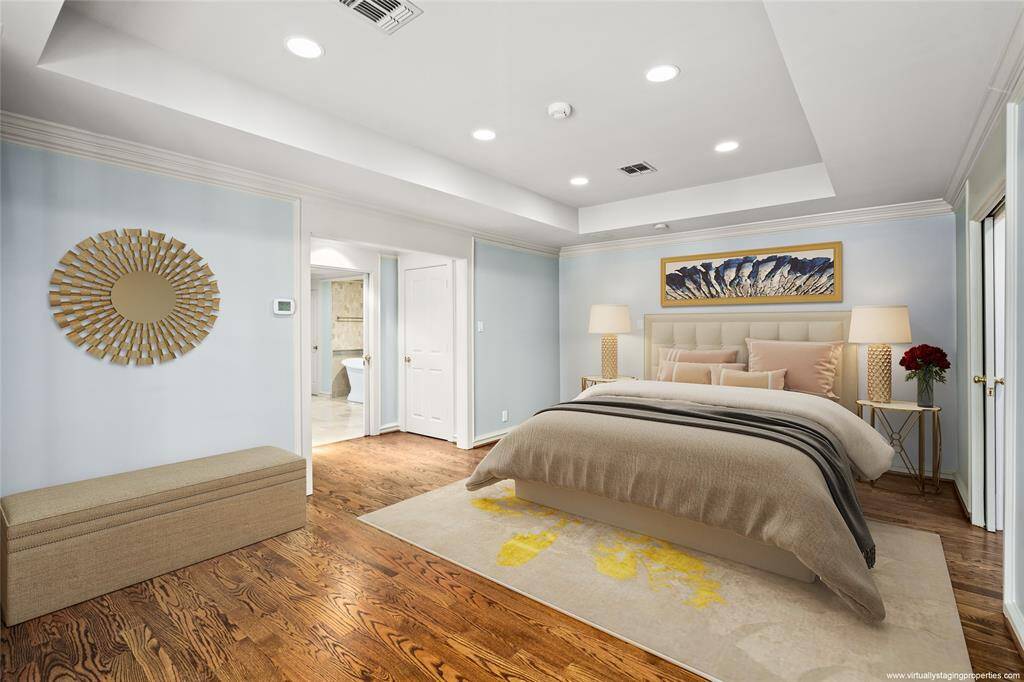 First floor primary bath (2023 updates per seller)with full wall framed mirrors, dual sinks and walk in shower with multiple shower heads and body sprayers. Crema Marfil marble floors.