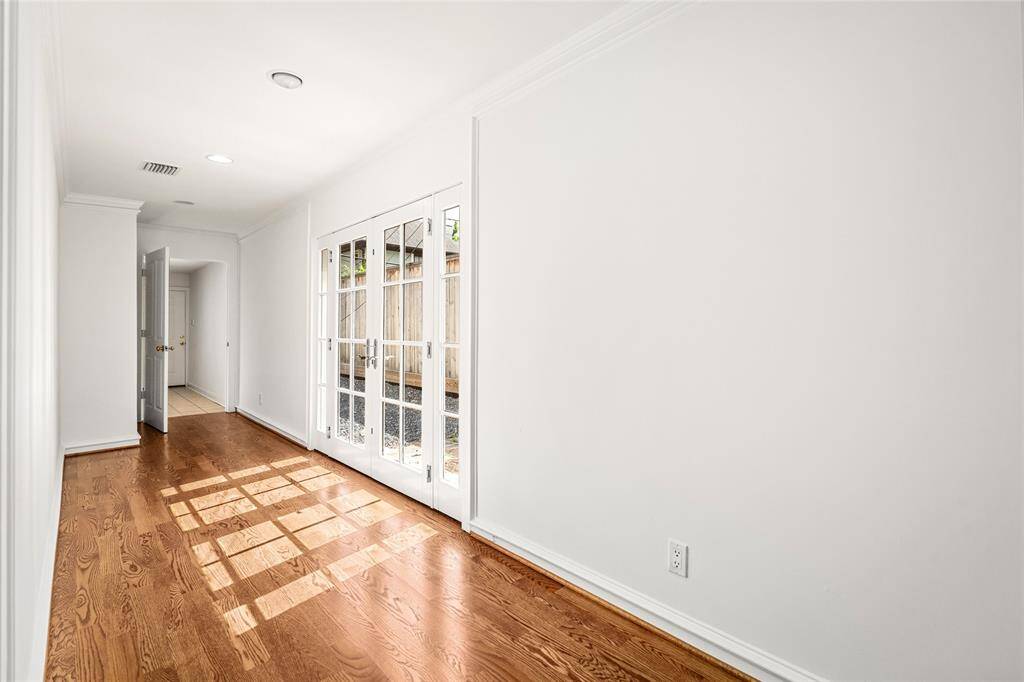 First floor utility area, with upper cabinets, storage closet, sink and door to the two-car garage.