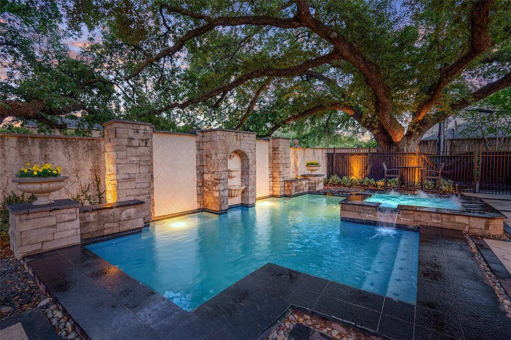 View of the amazing pool/spa and patio.  Beautiful mature oak tree canopies!