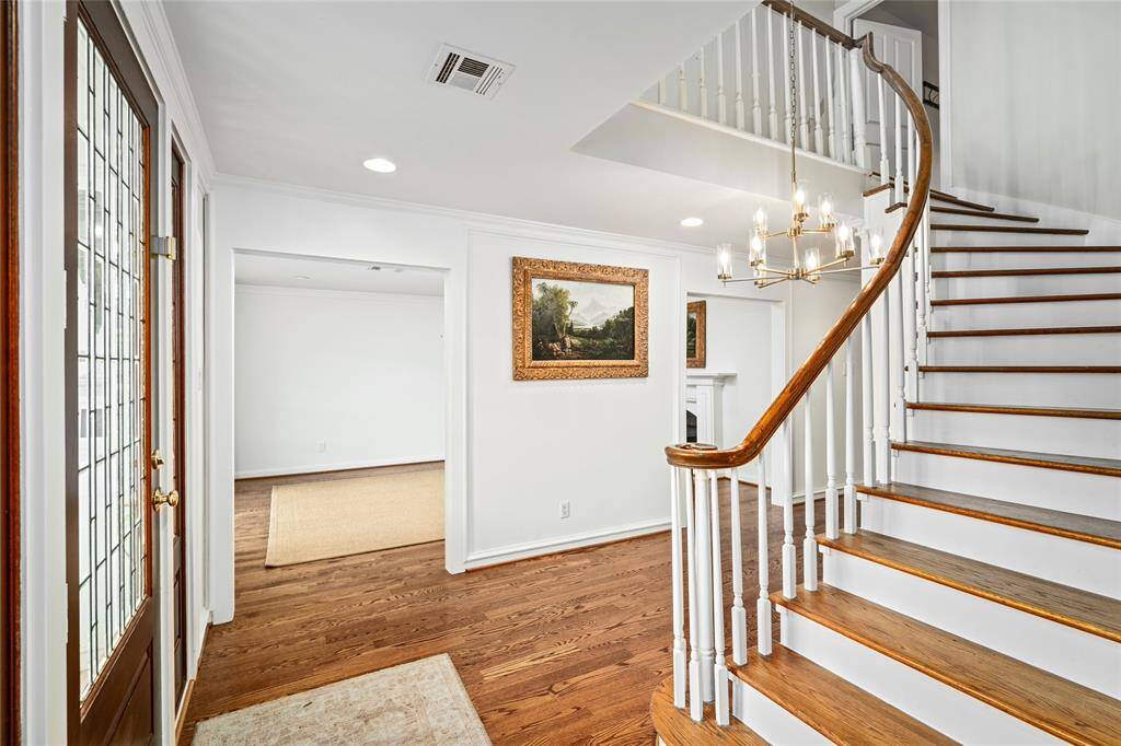 Newly installed hardwood floors and freshly painted (2023 per seller), and well-lit by the new designer chandelier. Spacious foyer separating the formals.
