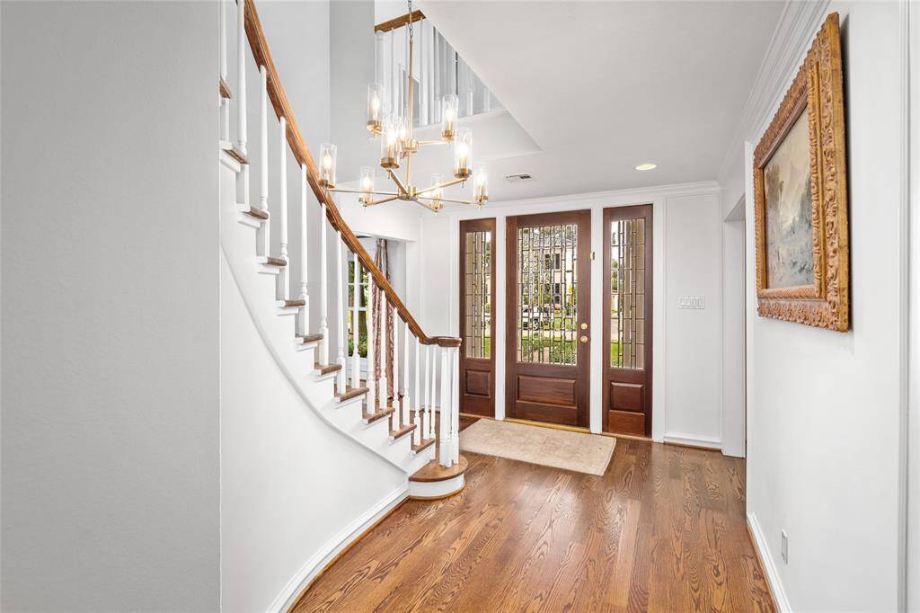 Gorgeous bay window with sheers and drapery panels in the formal Living Room. Both exterior bay windows have mosquito system installed (per seller). Virtually Staged.