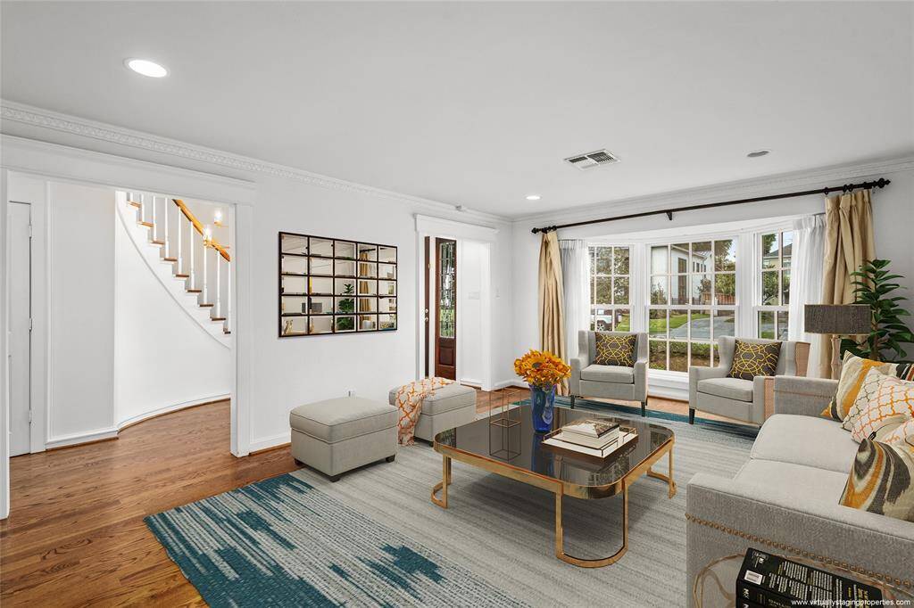 Another view of the formal Living Room. Gas-log fireplace, crown molding and seamless flow for entertaining. Virtually Staged.