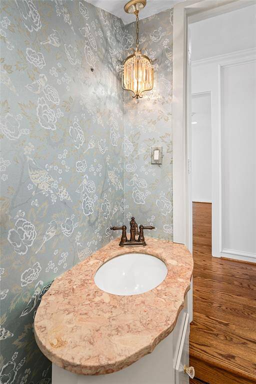 Family room with hardwood floors, multi-point locking French doors and large divided lite windows flood the room with natural light. Enjoy views of the patio, pool and spa.  The family room and adjacent kitchen are open concept and great for entertaining. Virtually Staged.