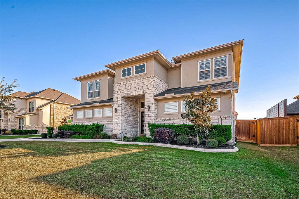 This stylish two-story home features a modern stone and stucco exterior, manicured landscaping, and a spacious front yard. Perfect for families seeking a blend of elegance and comfort in a desirable neighborhood.