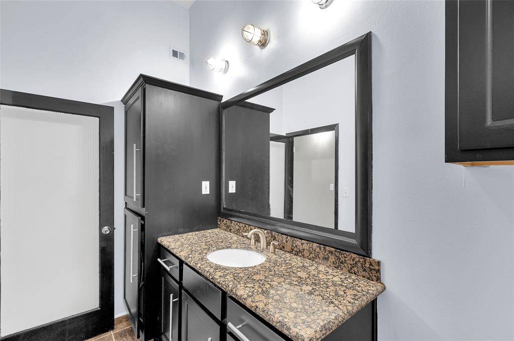 Another view of Bathroom cabinetry. Large cabinets at far end house the washer and dryer seen in next pic.  Door from Hallway to Bath is diffused glass with wood trim!