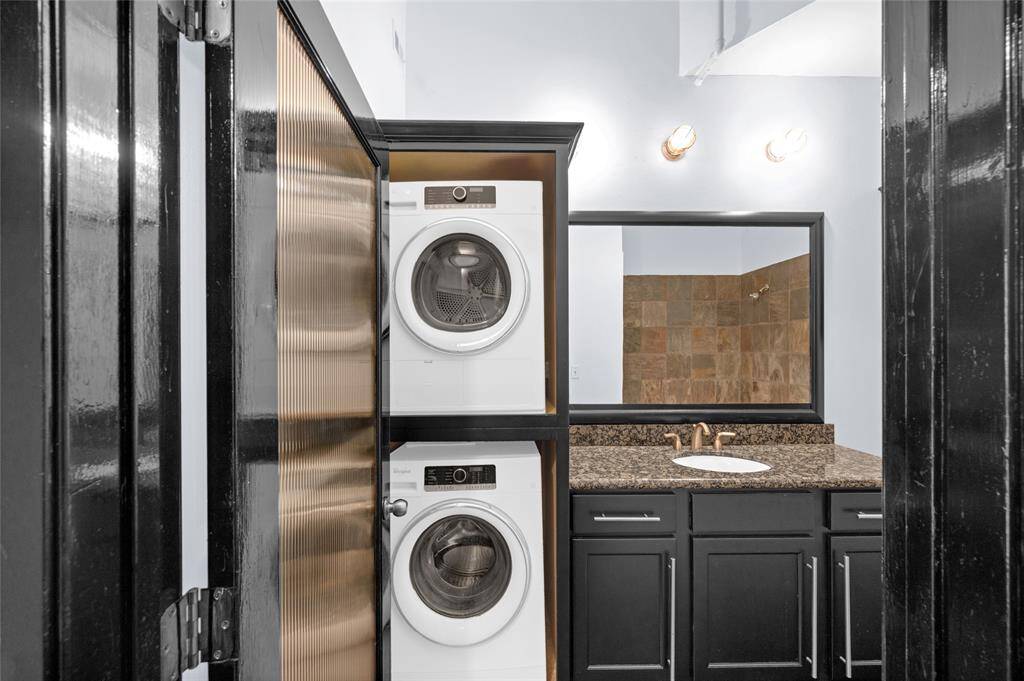 The washer and dryer are stored behind the cabinet doors of the vanity, how clever!   Washer, dryer, refrigerator and all appliances are included in sale of unit!  1 assigned garage parking space is included as well!