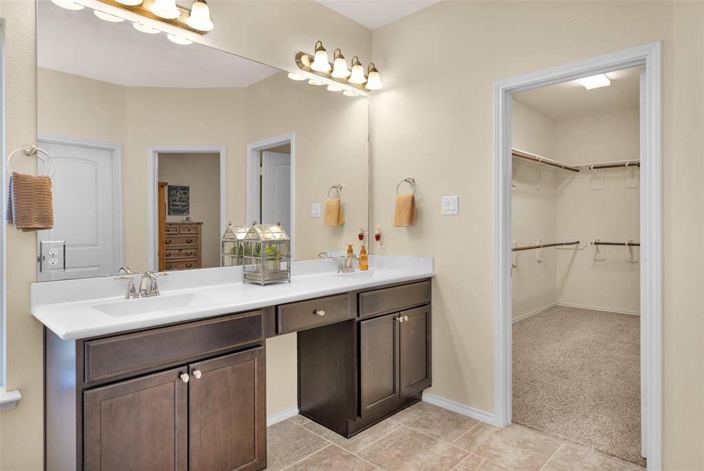 Double sinks and vanity area in primary bath.