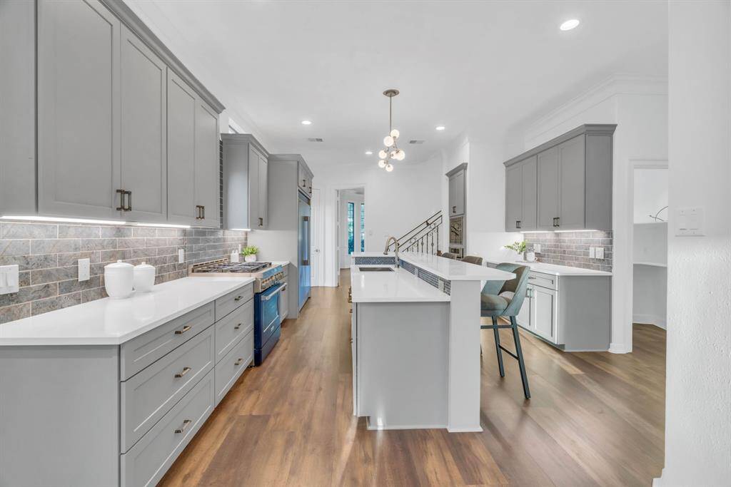 The modern kitchen boasts sleek quartz countertops, under-cabinet lighting, and soft-close drawers, creating a functional yet elegant space. Every detail has been thoughtfully designed to give the chef everything needed to craft culinary masterpieces in a truly magical environment.