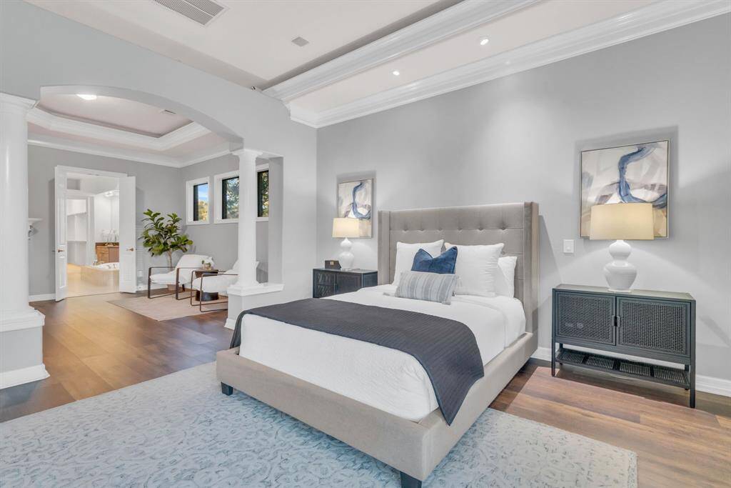The primary suite is truly a luxurious retreat, offering an abundance of space, additional lighting, and a cozy sitting area. A fireplace adds warmth and ambiance, while seamless access to your own spa-like bathroom completes this serene sanctuary.
