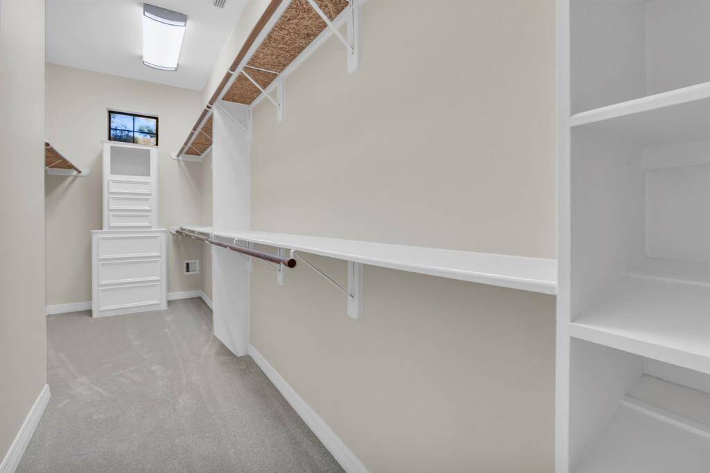 The 2nd primary walk in closet with built ins. New carpet 2024!