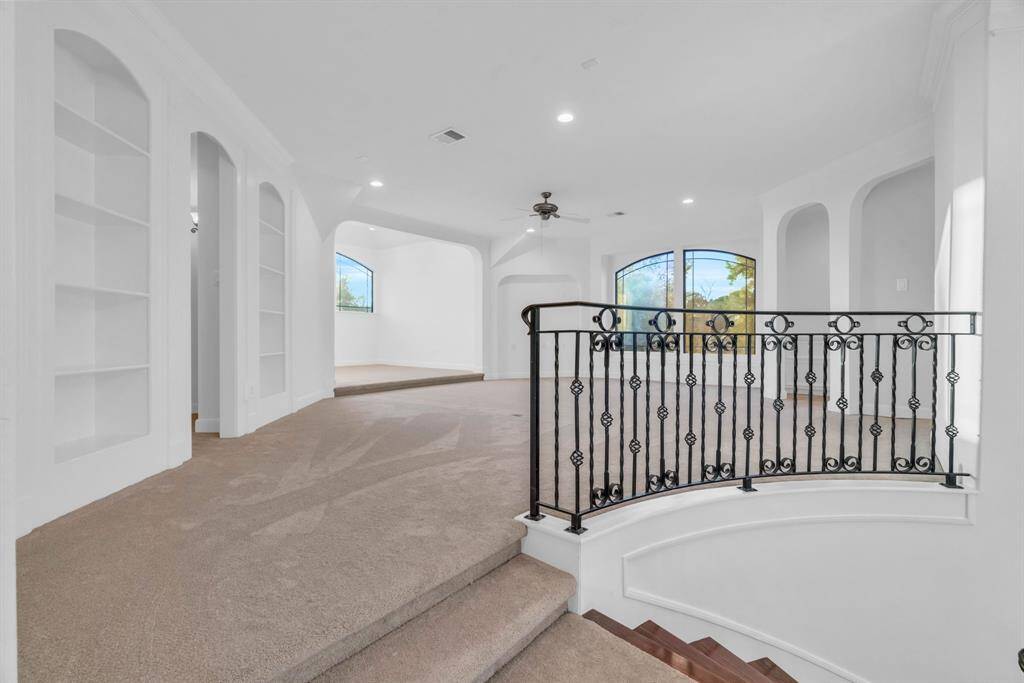 Upstairs is the MASSIVE game room that could be a media room, playroom, theatrical room. It offers built in bookshelves, a wet bar and a built in desk area.