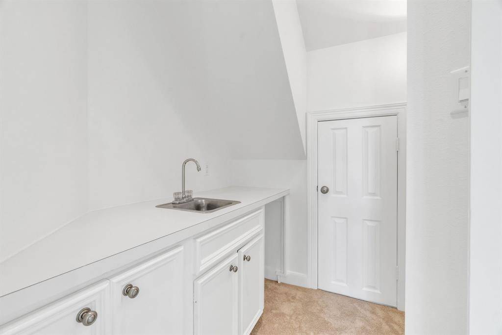 The wet bar off of the game room. The door provides attic access.