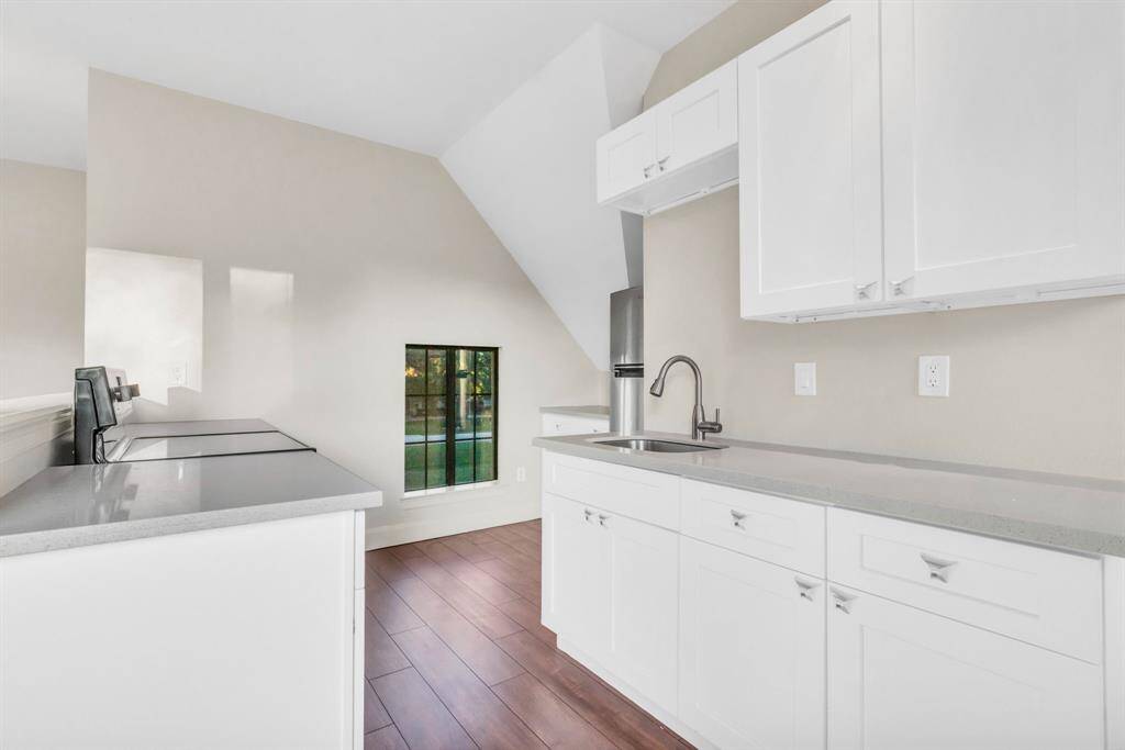 The In-law/Nanny Apartment Addition (2019) includes a fully updated kitchen, featuring new LVT flooring, a modern range, refrigerator, countertops, cabinets, sink, faucet, and garbage disposal. A new interior door adds a touch of privacy and functionality, making this space both practical and stylish for any guest or family member.