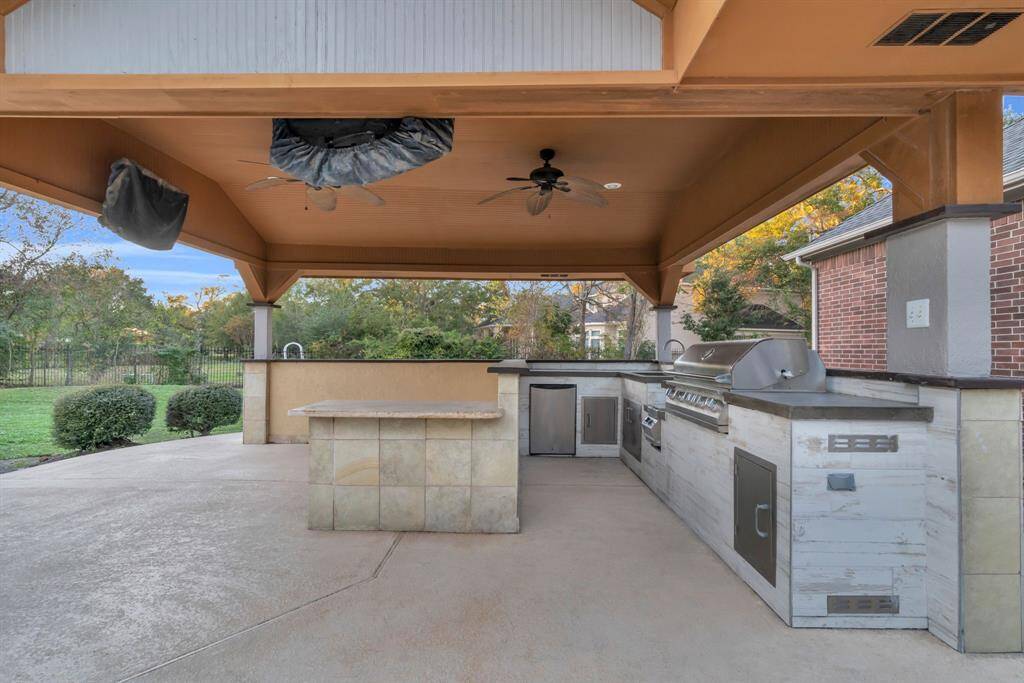 The covered outdoor kitchen is AMAZING! The kitchen features a stunning new concrete countertop, adding a sleek, modern touch. Enjoy the convenience of a new on-demand tankless hot water system, paired with a new sink and faucet. For outdoor cooking, a brand-new, unused gas grill awaits, ready to elevate your entertaining experience.