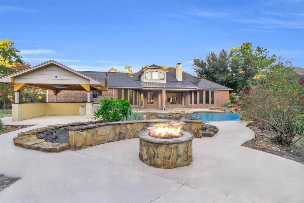 Behind the pool, a spacious sitting area with a firepit awaits, offering the perfect spot to relax with family and friends. Gather around the fire, share stories, and enjoy the warmth of the flames under the vast Texas night sky.