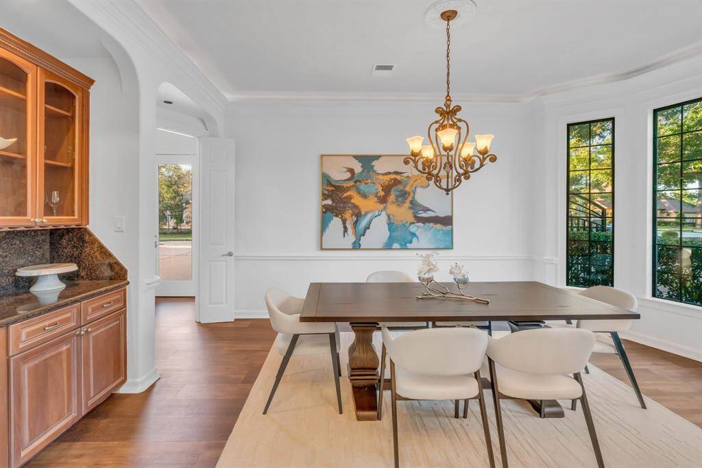 To the right of the grand foyer, the formal dining room awaits—spacious enough to host memorable holiday feasts or lively dinner parties. Adding a touch of sophistication, the room features its own butler’s pantry, perfect for showcasing your finest wines and cherished china.