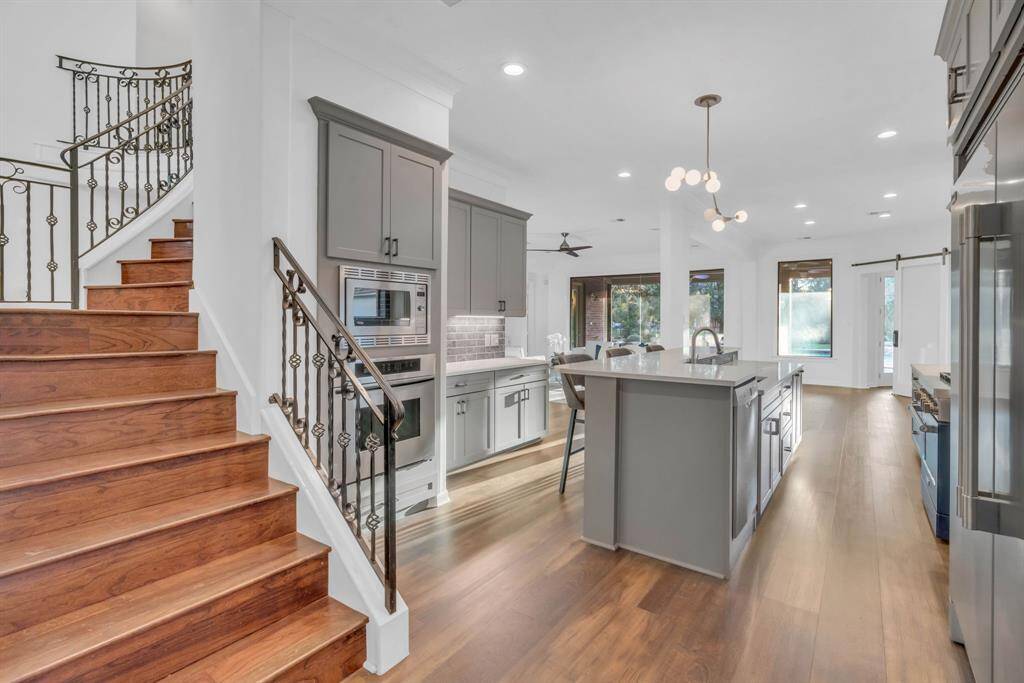 Just beyond the formal dining room lies the fully renovated kitchen, a true chef’s delight. This stunning space also features a second staircase, providing convenient access to the upstairs while adding charm and functionality to the home.