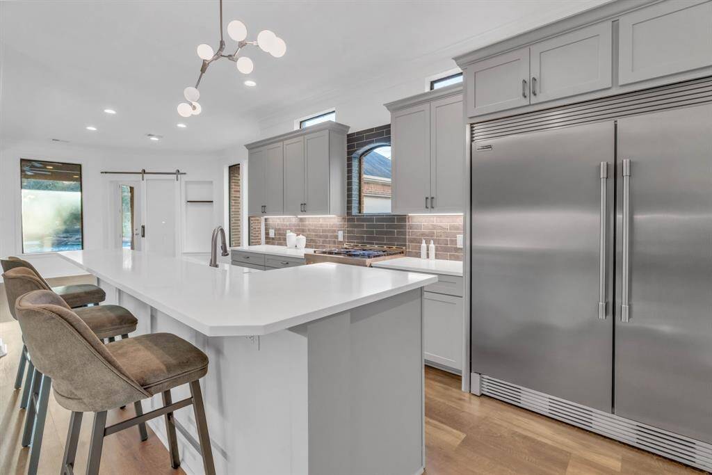 The fully renovated kitchen is a chef’s dream, offering high-end appliances, including a Frigidaire Professional Series 66” Side-by-Side Column Refrigerator and Freezer set, and a KitchenAid 36” Smart Commercial-Style 6-Burner Gas Range. This exceptional culinary space combines style and functionality, ready to inspire gourmet creations and memorable gatherings.