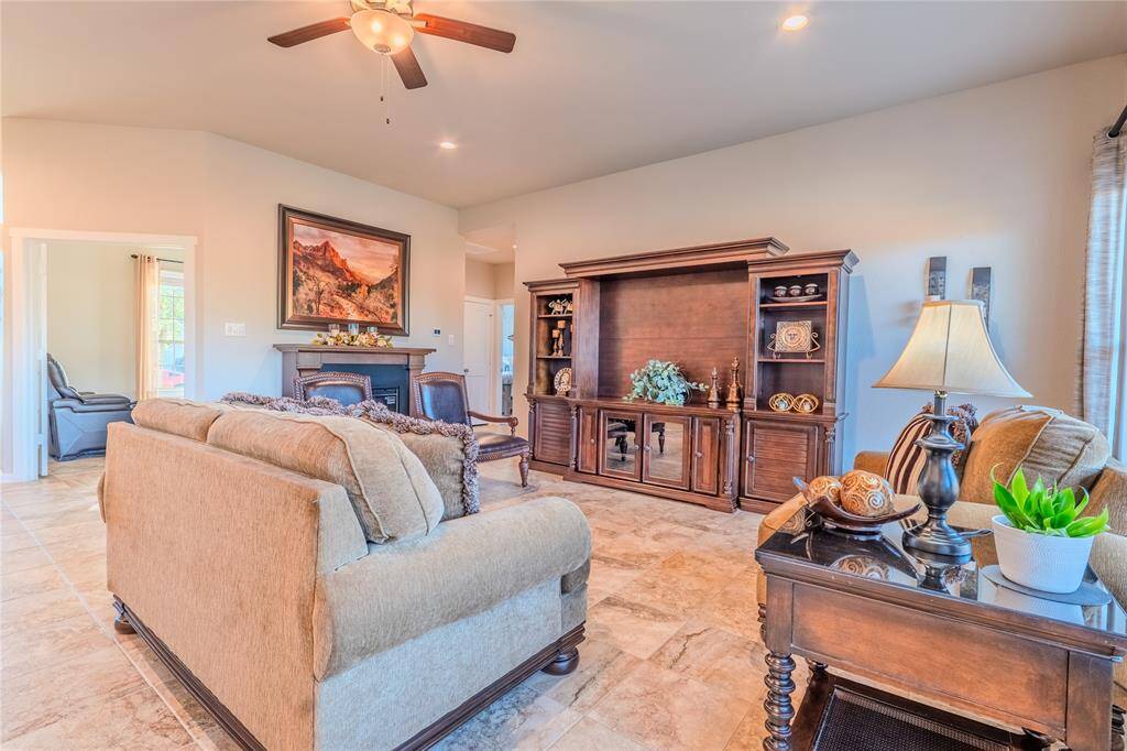 The living room features elegant tile flooring, and recessed lighting, creating a warm and inviting space perfect for relaxing or entertaining.