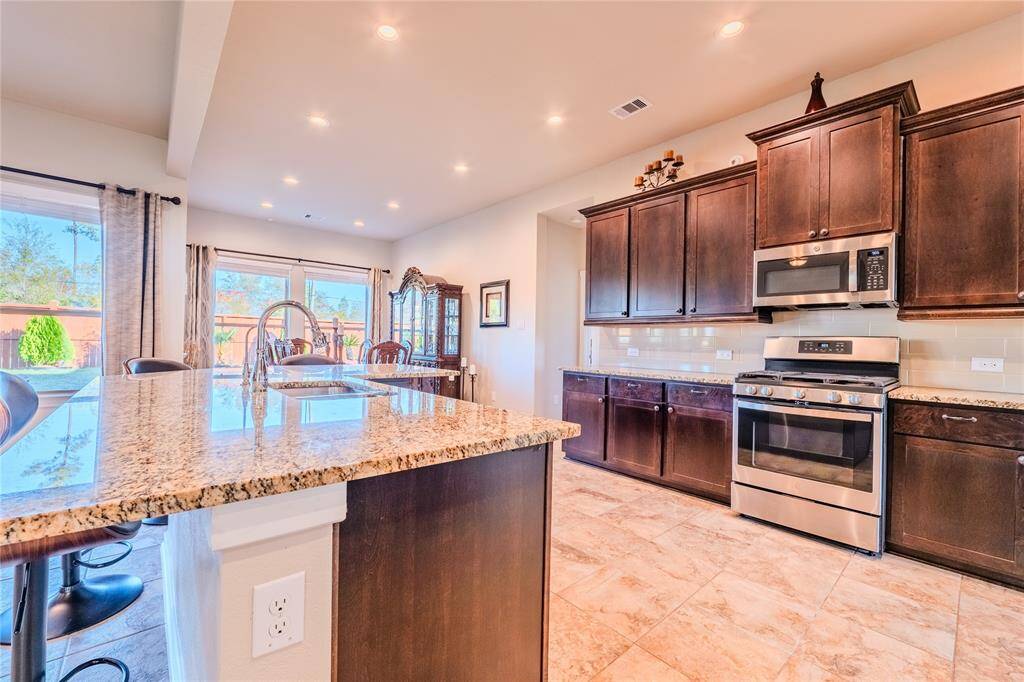 The kitchen offers plenty of counter space and storage, with an open design that flows into the living area for easy entertaining.