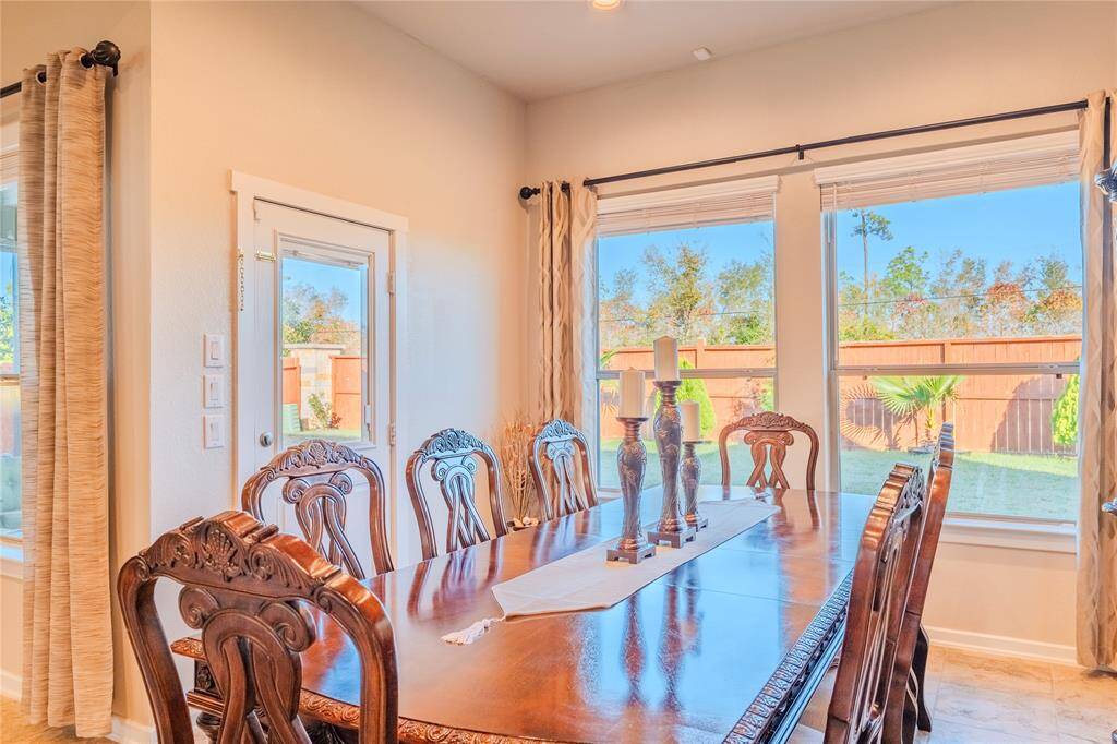 The dining area seamlessly flows into the kitchen and living spaces, perfect for entertaining guests or enjoying family meals.