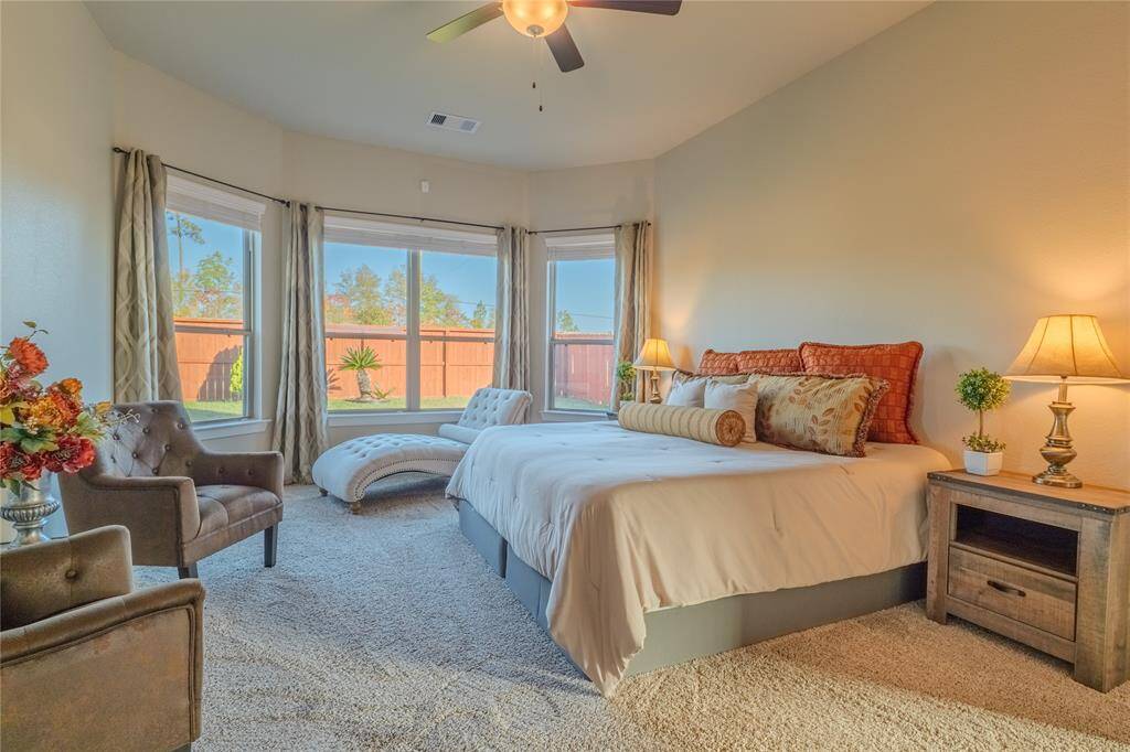 The primary bedroom provides a tranquil retreat with plush carpeting and ample space for relaxation.