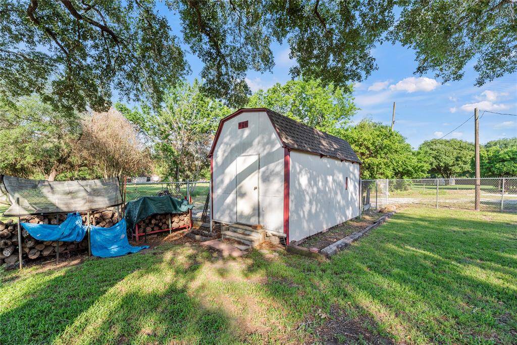 Storage shed with firewood to be left on the property.