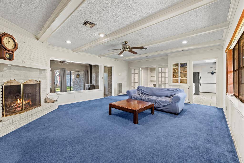 Spacious living room has wood-burning fireplace and charming features of an era gone by.