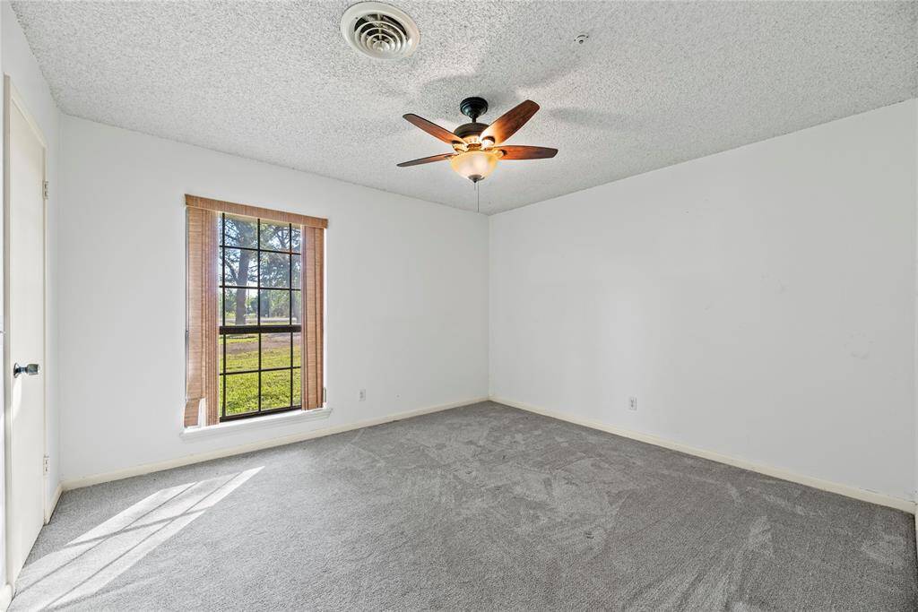 Secondary bedroom has large walk-in closet and sits at the front of the house.