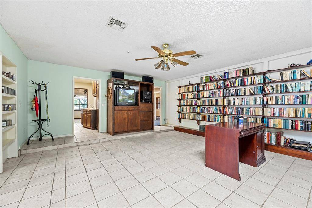 Large space feeds into the study and other entrance goes into half bath/laundry room and kitchen area.