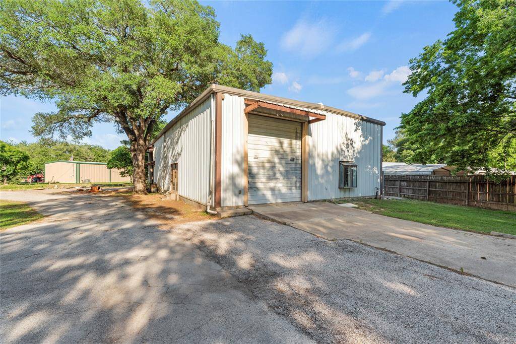 Large metal building with 3 automatic rolling doors,main office entrance, working full bathroom, kitchen area, office space. Plenty of parking with direct access to FM 359.
