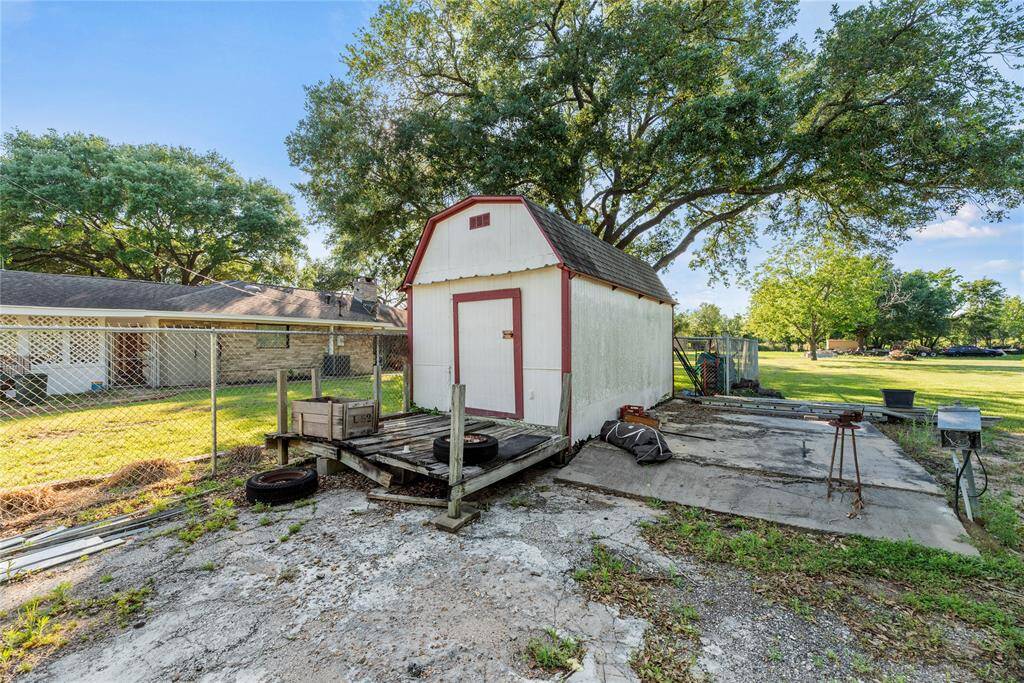 Storage shed. Concrete pad might be a great place to park an RV.