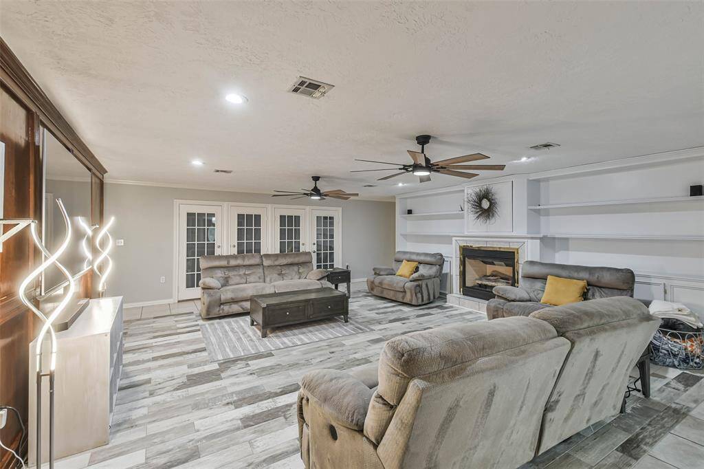Living room with view of fireplace and shelves for all of those family picture!