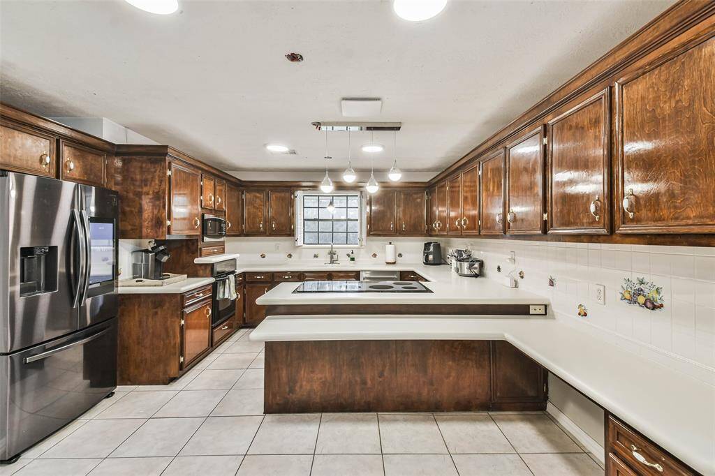 The Kitchen offers Corian countertops, electric cooktop and lots of cabinet space.
