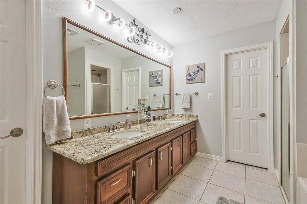 The primary bathroom offers double sinks, tub and separate shower.