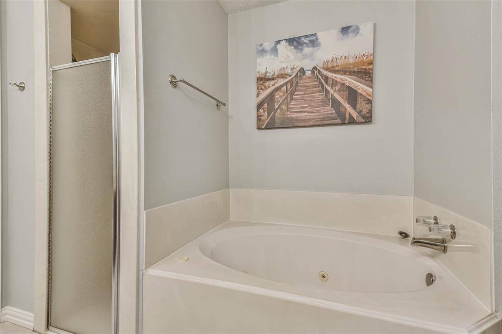 Tub and shower in primary bedroom.