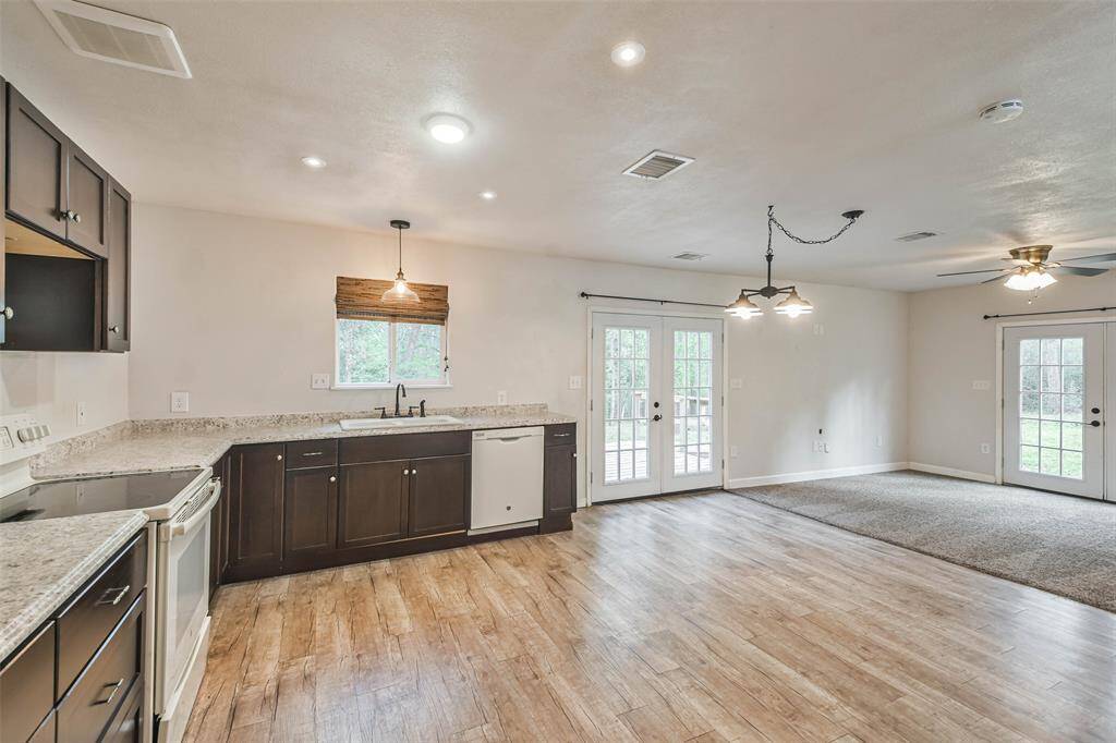 View of kitchen with living room on the right.