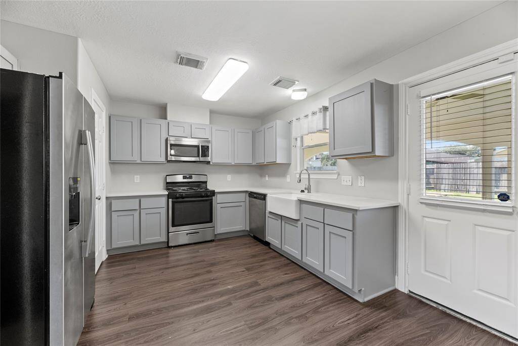 Your fully renovated chef-inspired kitchen features easy care countertops, stainless steel appliances, tons of light, and richly painted cabinets with easy access to the backyard.